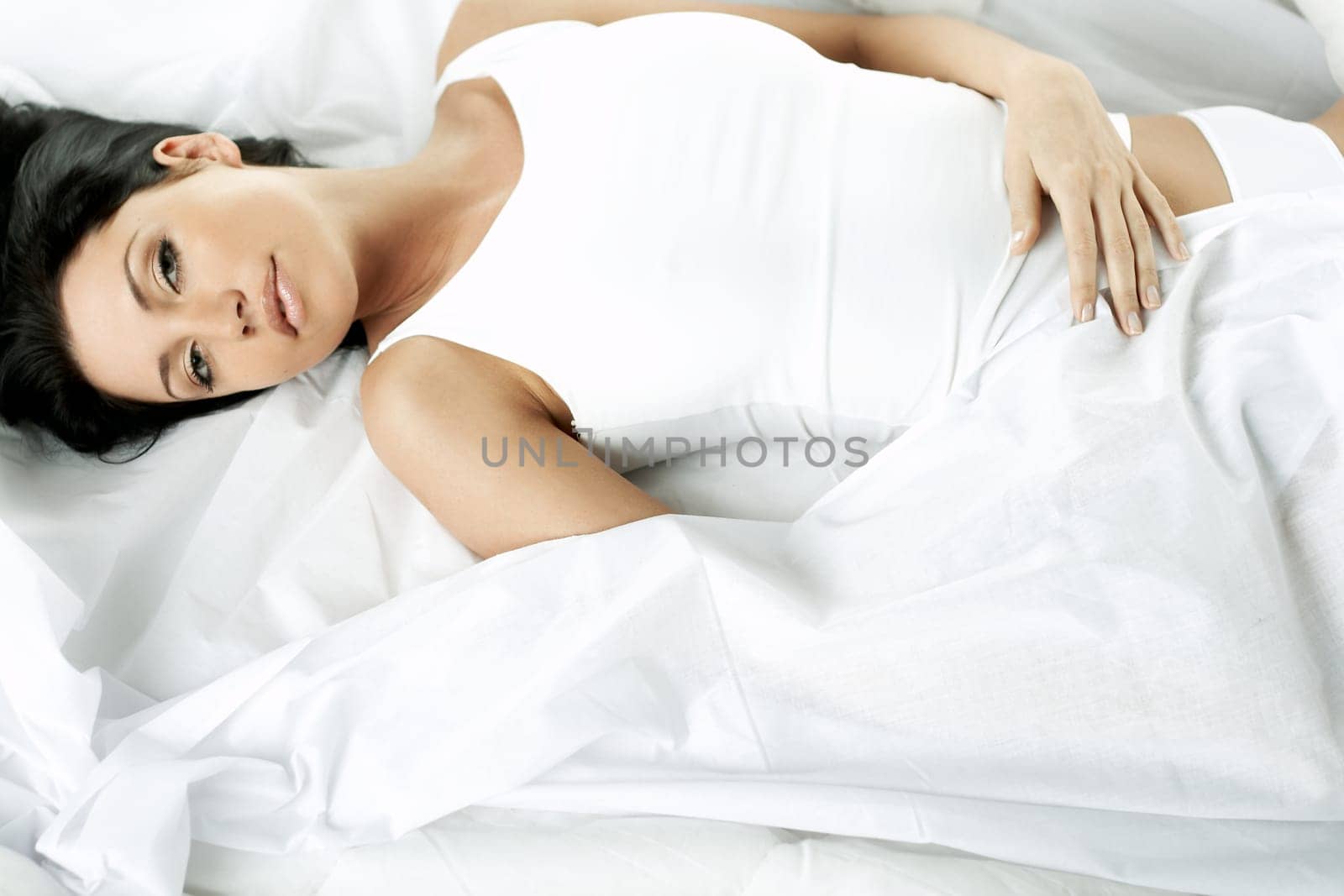 Portrait of Fresh and Beautiful brunette woman on bed