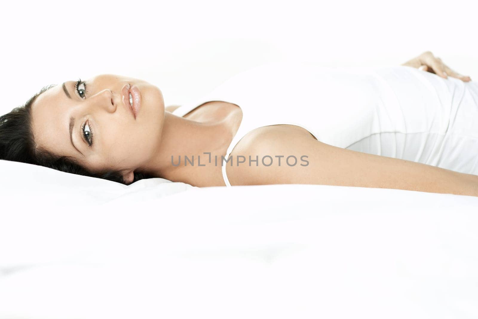 Portrait of Fresh and Beautiful brunette woman on bed