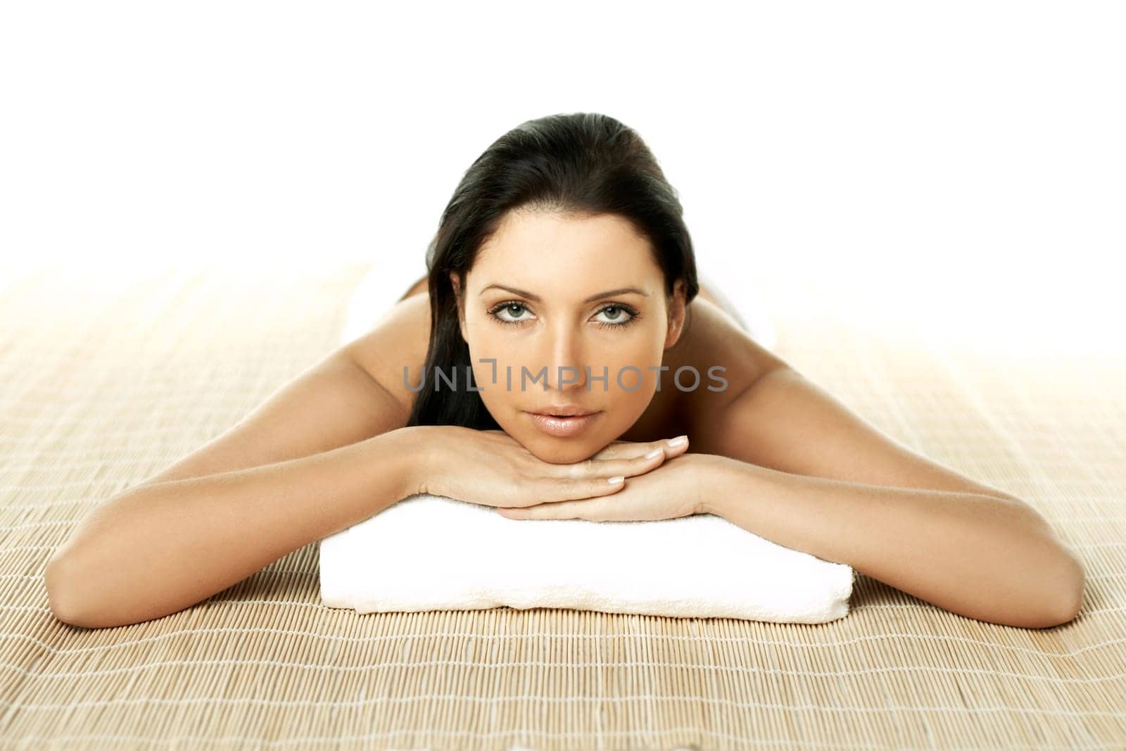 Portrait of Fresh and Beautiful brunette woman laying on bamboo mat