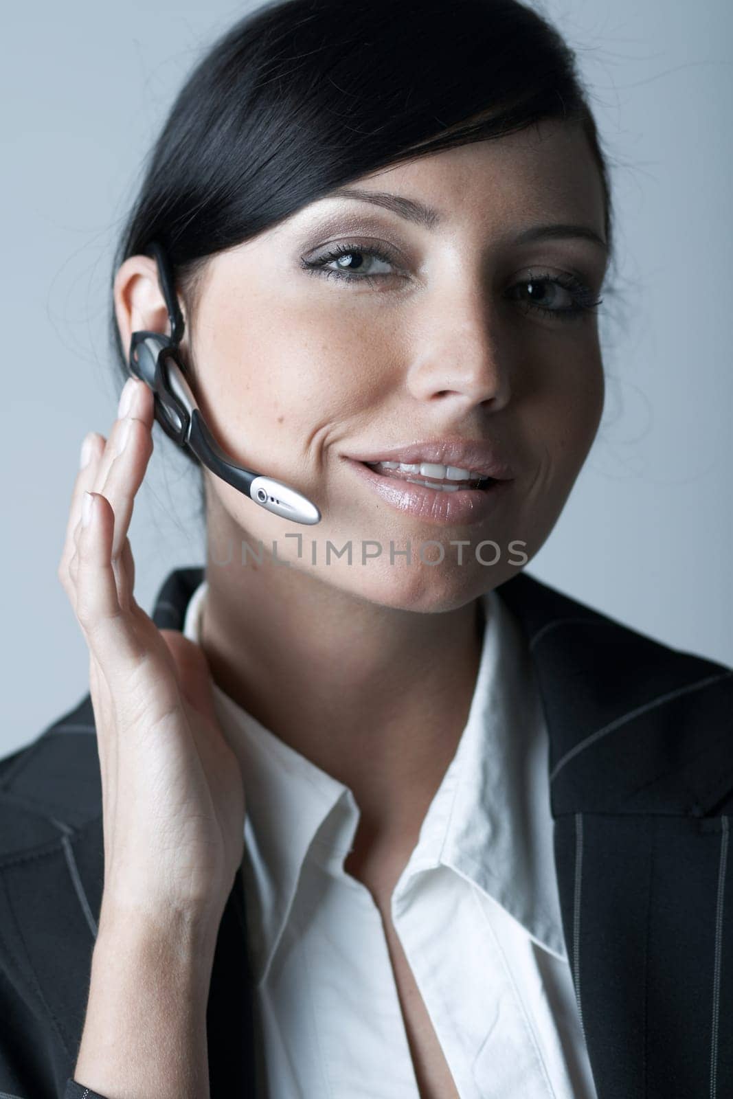 Beautiful and sexy brunette business woman talking telephone. She is isolated on clear background