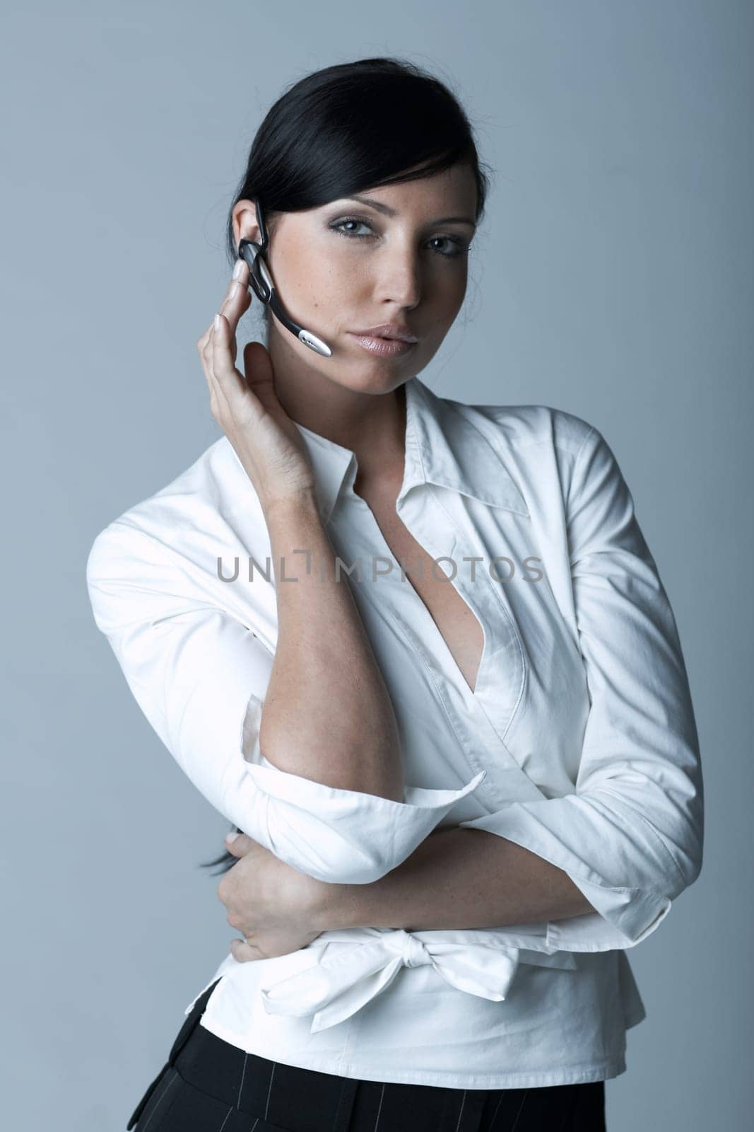 Beautiful and sexy brunette business woman talking telephone. She is isolated on clear background