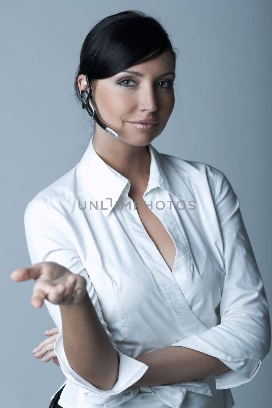 Beautiful brunette business woman with wireless headset isolated on clear background