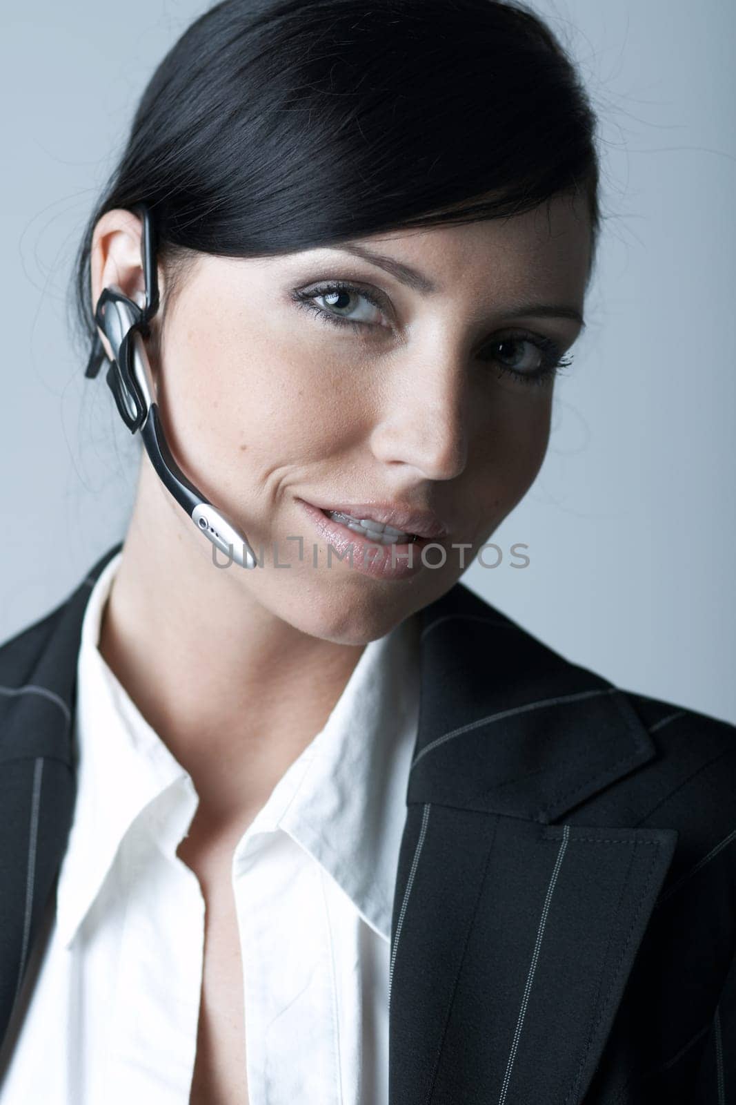 Beautiful and sexy brunette business woman talking telephone. She is isolated on clear background