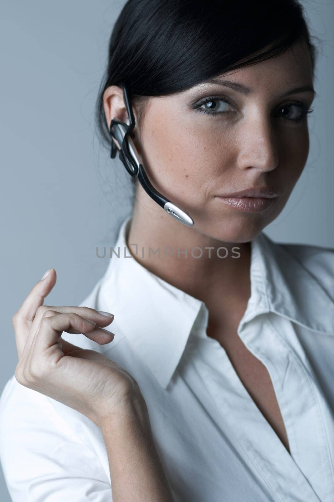 Beautiful and sexy brunette business woman talking telephone. She is isolated on clear background