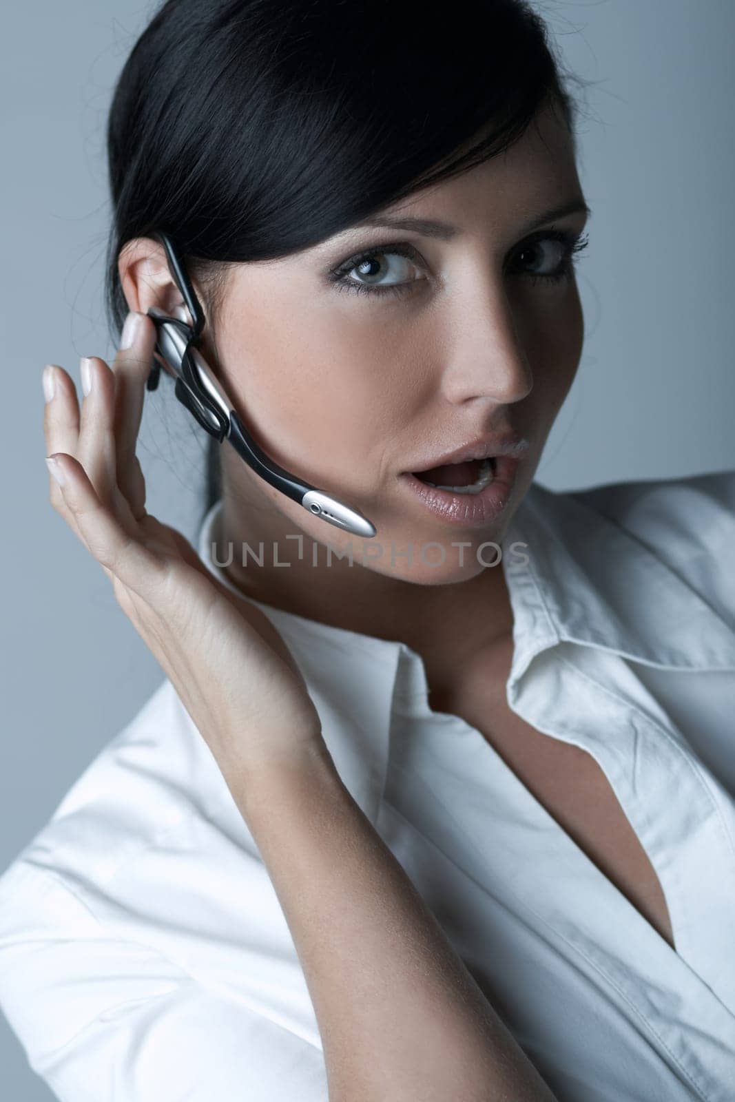 Beautiful brunette business woman with wireless headset isolated on clear background