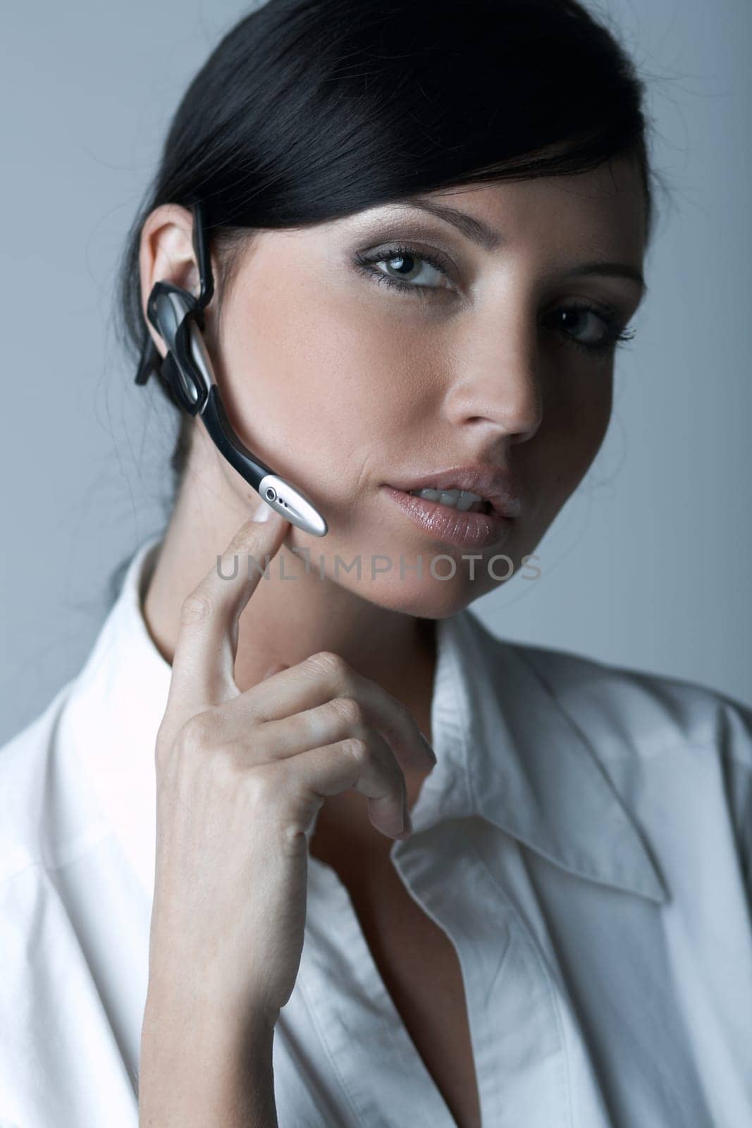 Beautiful brunette business woman with wireless headset isolated on clear background