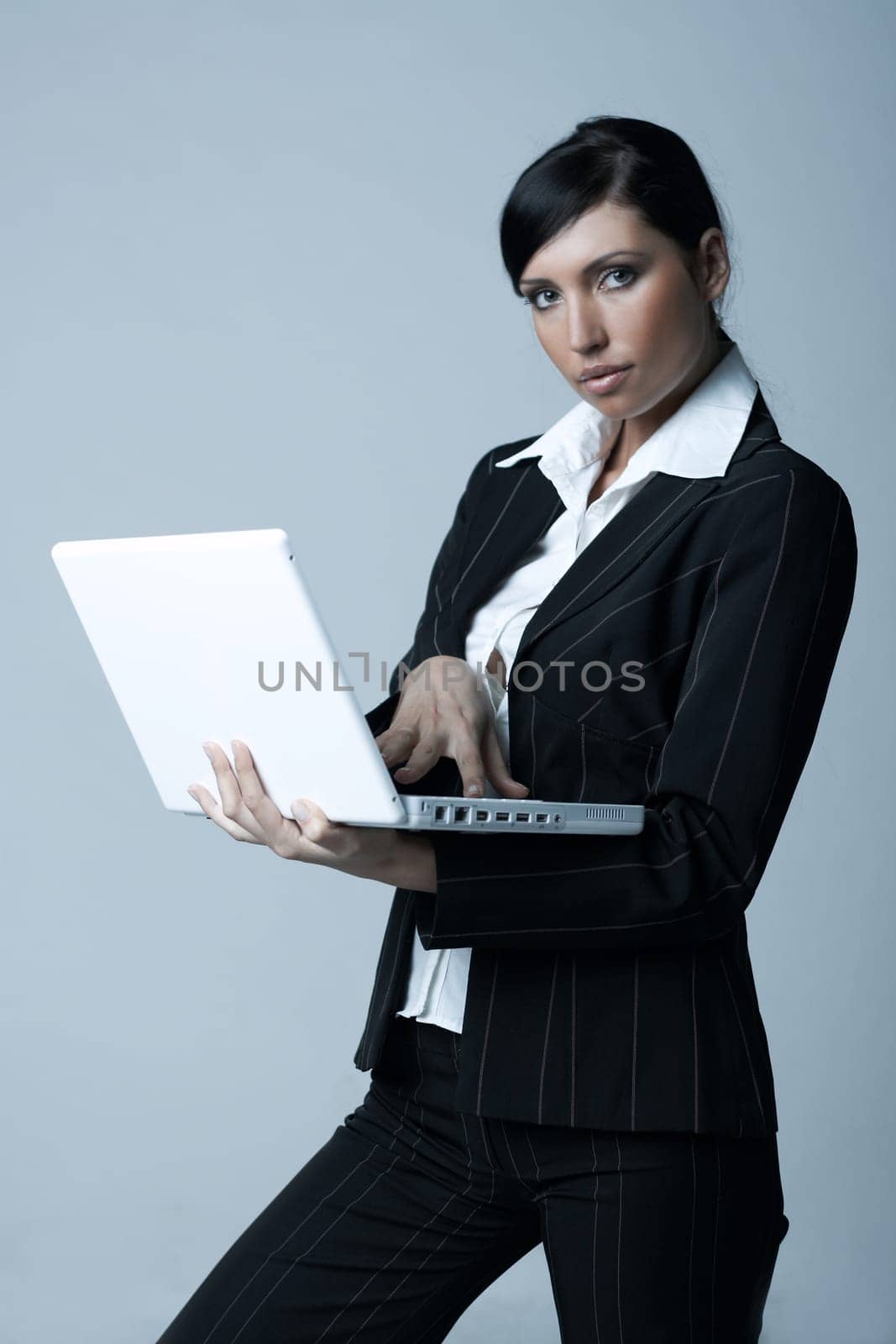 Beautiful brunette business woman with laptop computer isolated on clear background