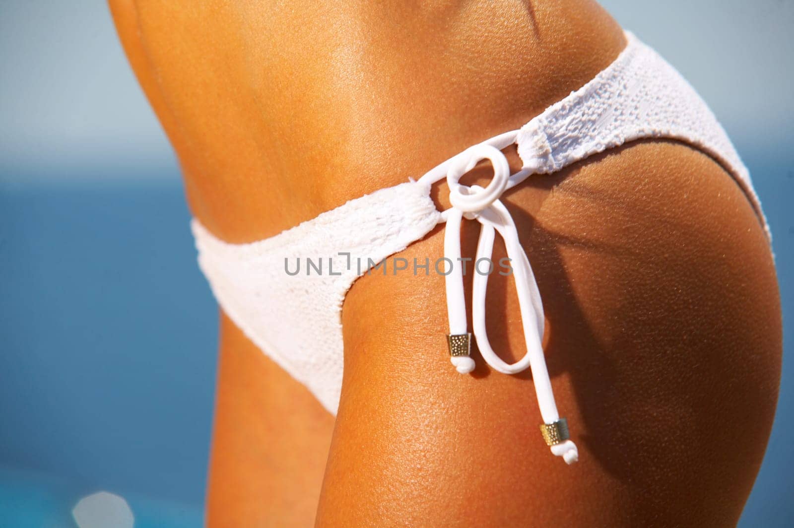 Beautiful young Sexy woman body in bikini during sunbath next to swimming pool