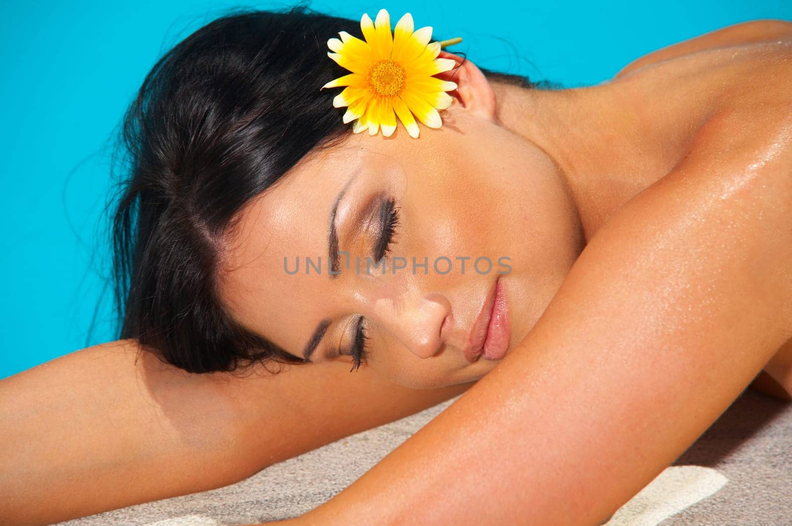 Beautiful young Sexy woman laying in bikini during sunbath next to swimming pool