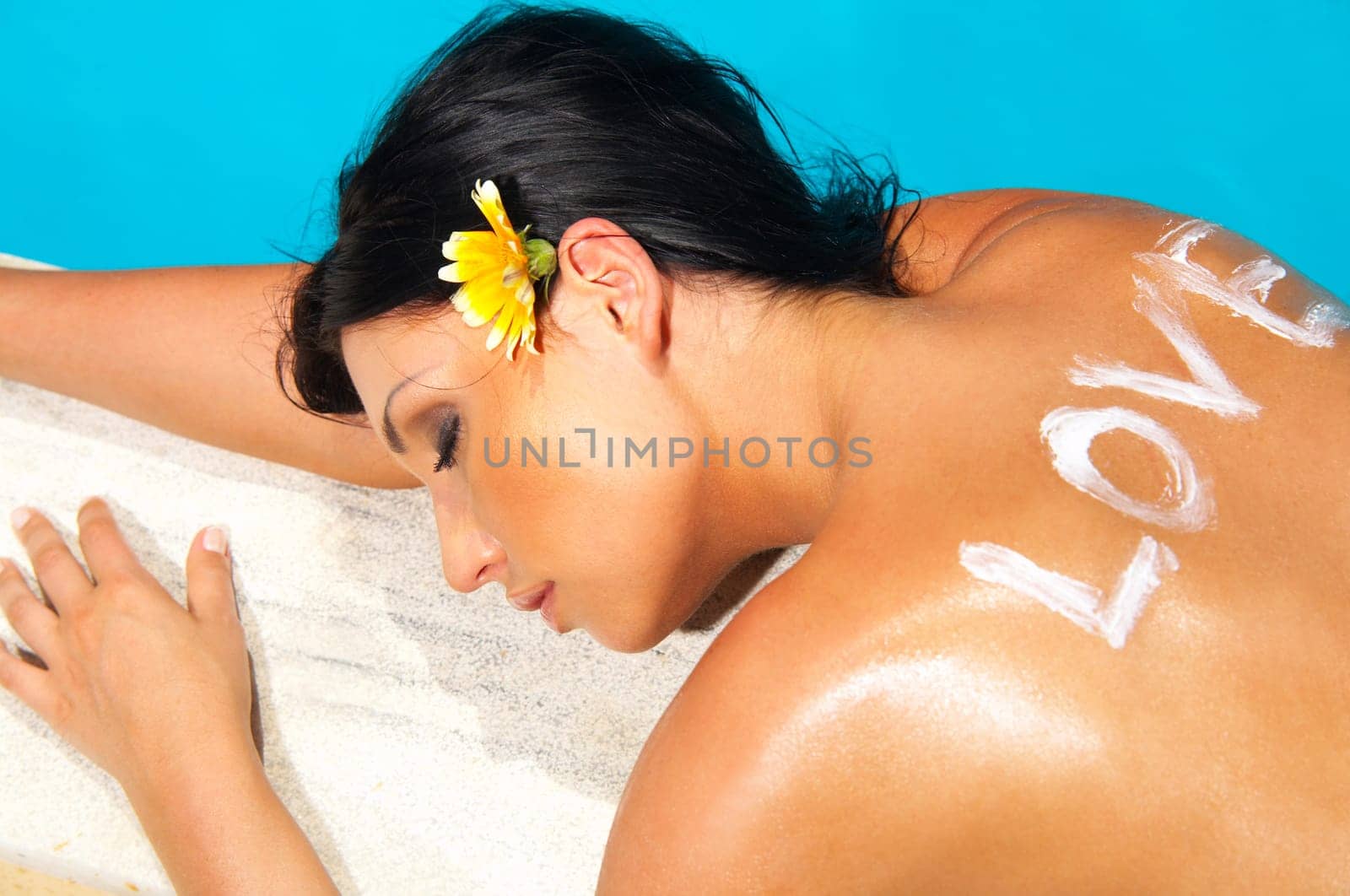 Beautiful young Sexy woman laying in bikini during sunbath next to swimming pool