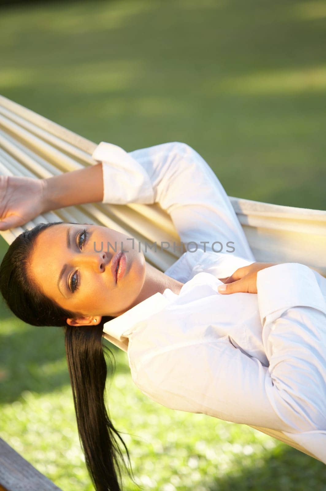 20-25 years woman portrait ralaxing on hammock at exotic surrounding, bali indonesia