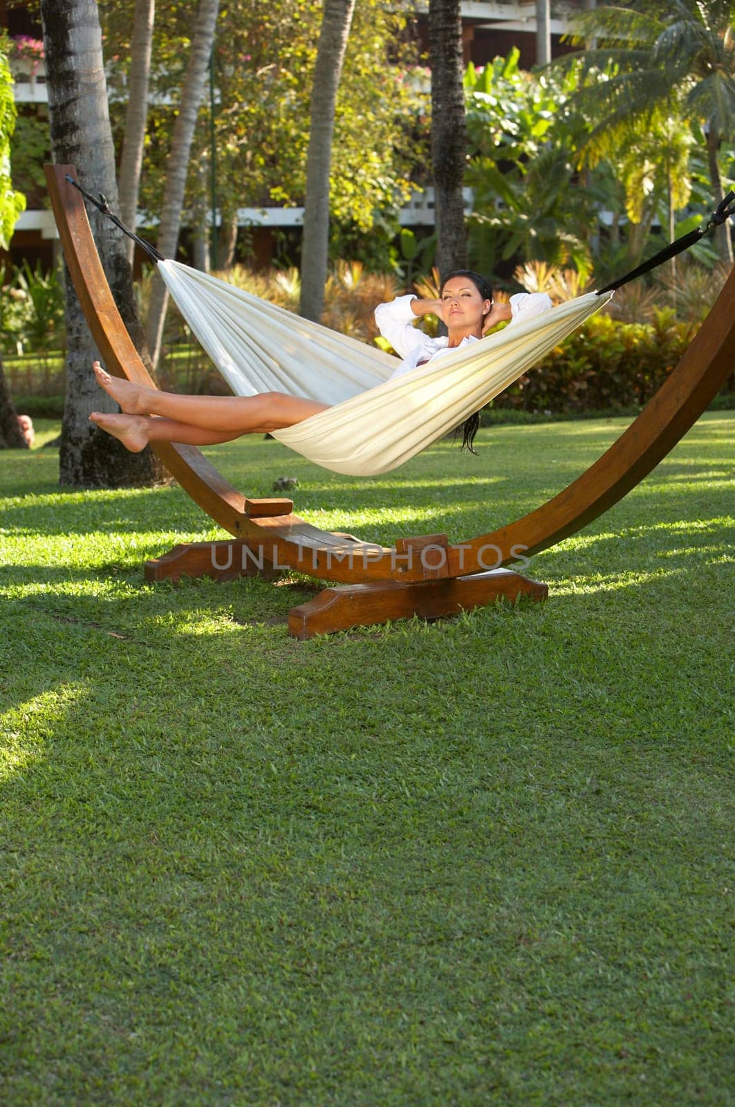 20-25 years woman portrait ralaxing on hammock at exotic surrounding, bali indonesia