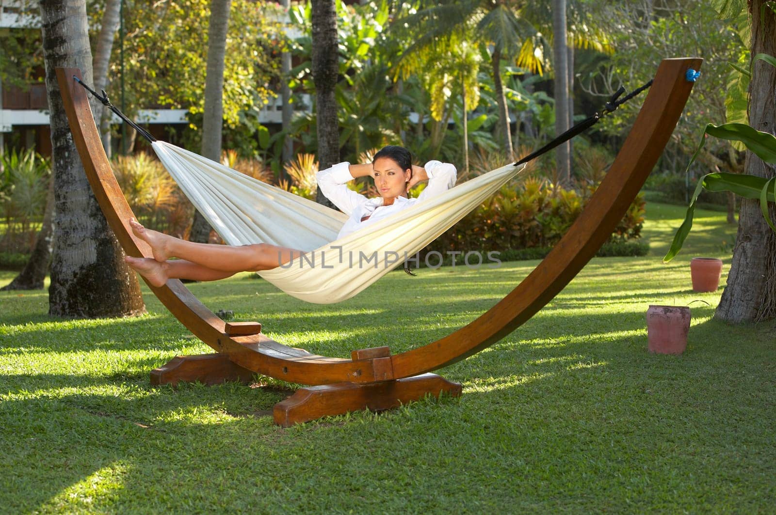 20-25 years woman portrait ralaxing on hammock at exotic surrounding, bali indonesia
