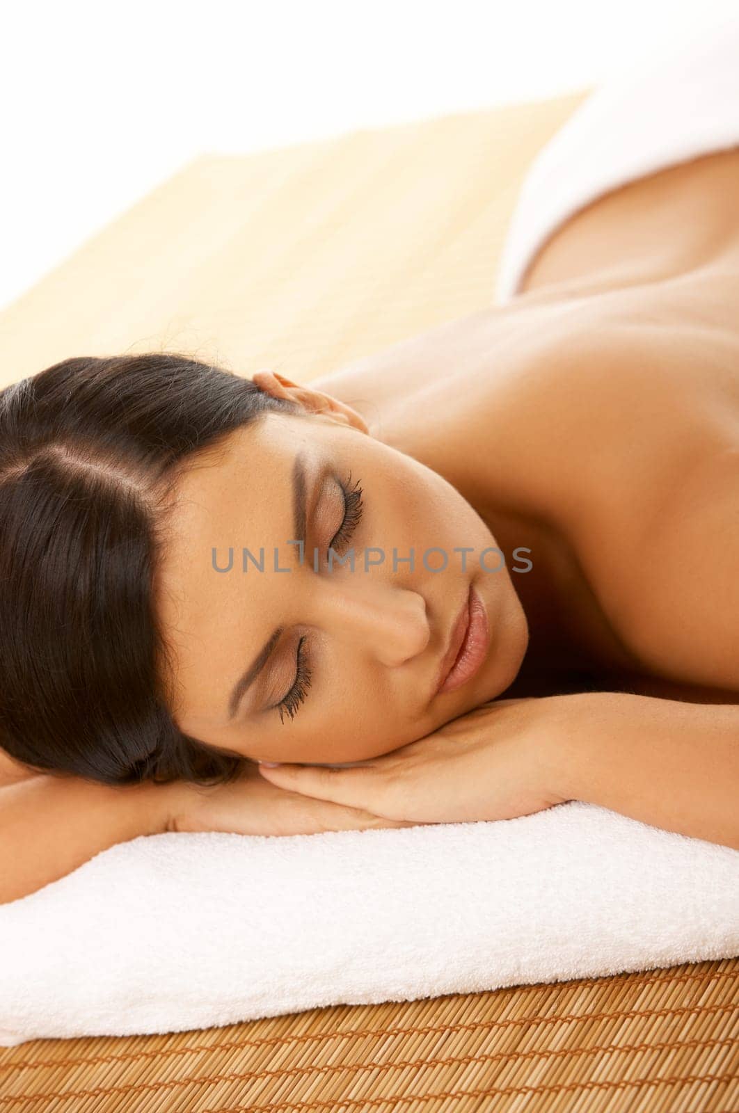 Portrait of Fresh and Beautiful brunette woman laying on bamboo mat