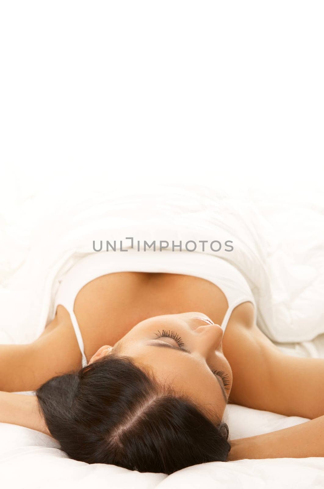Portrait of 20-25 years old beautiful woman on white bed