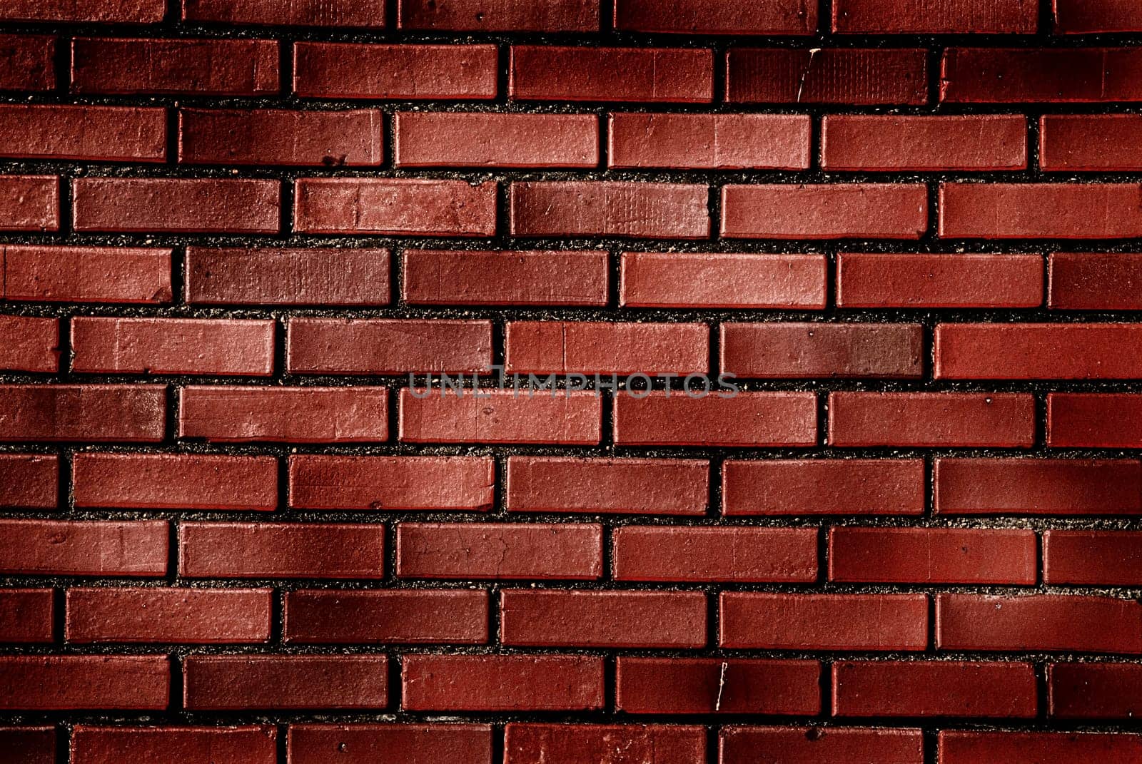 Image of a red brick wall with mottled lighting
