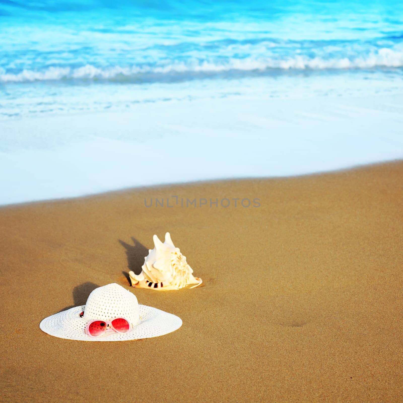 Hat, tube and sunglasses on the beach