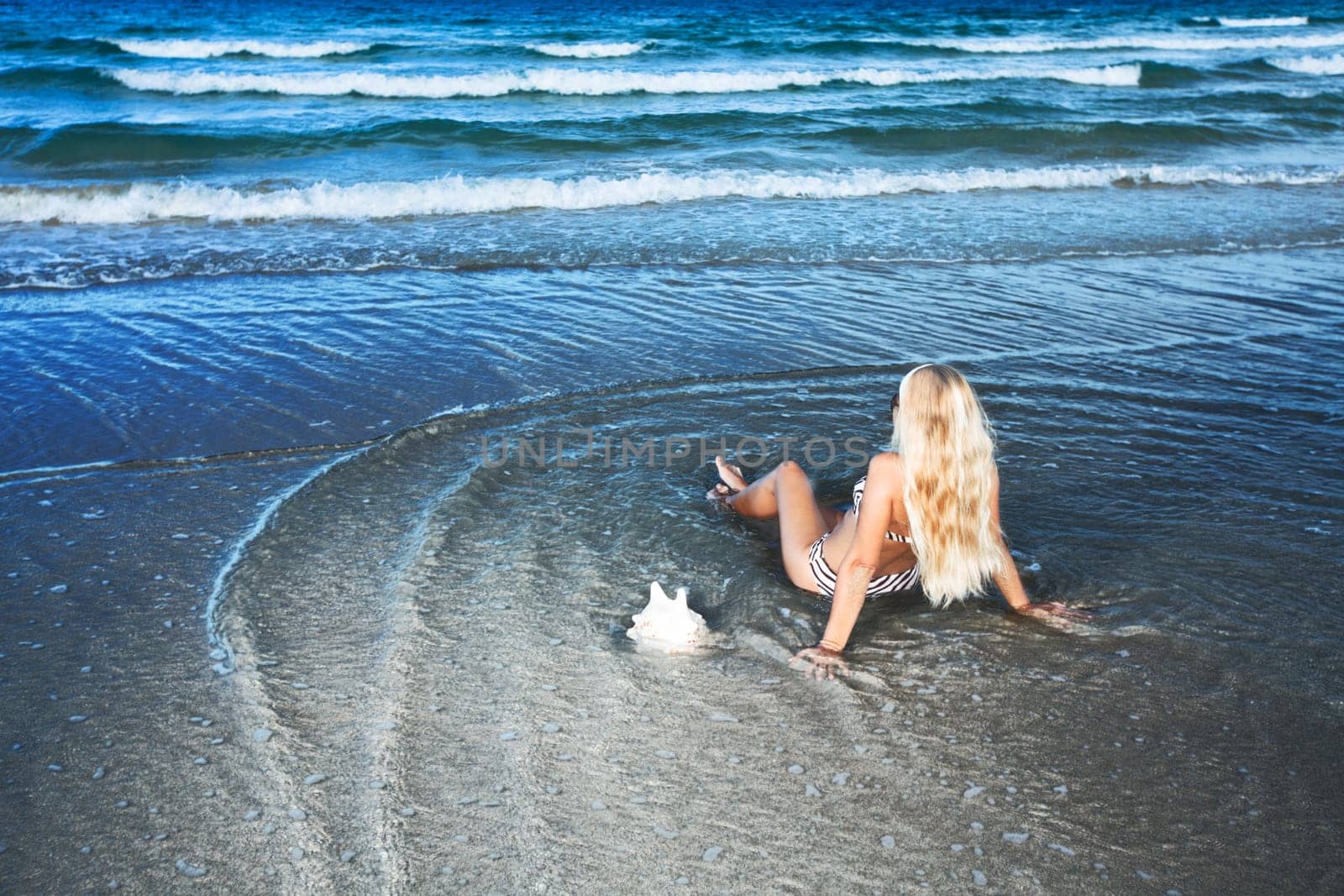 Young woman in bikini at the tropical beach