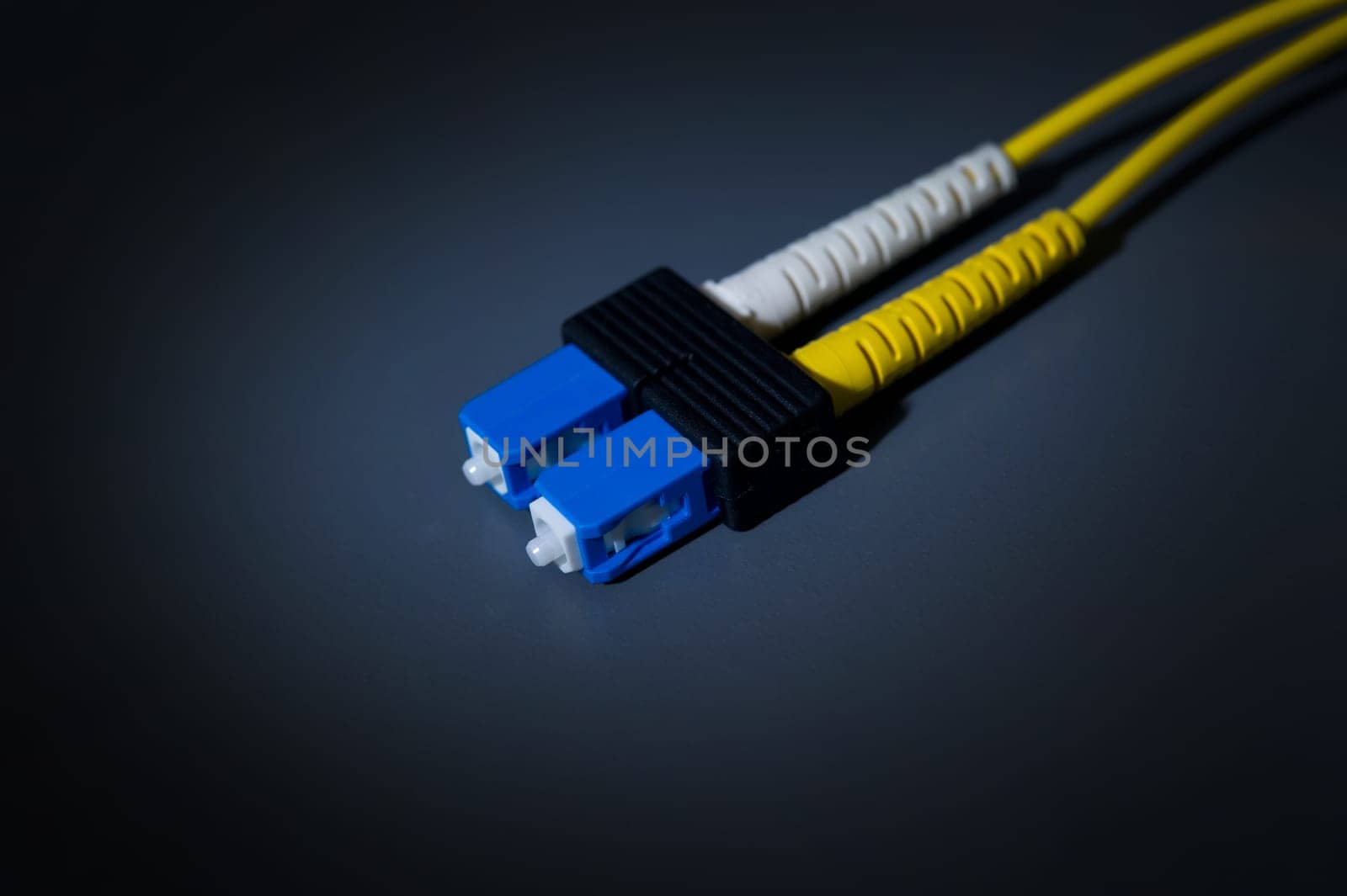Image of fiber optic cable connectors on gray background