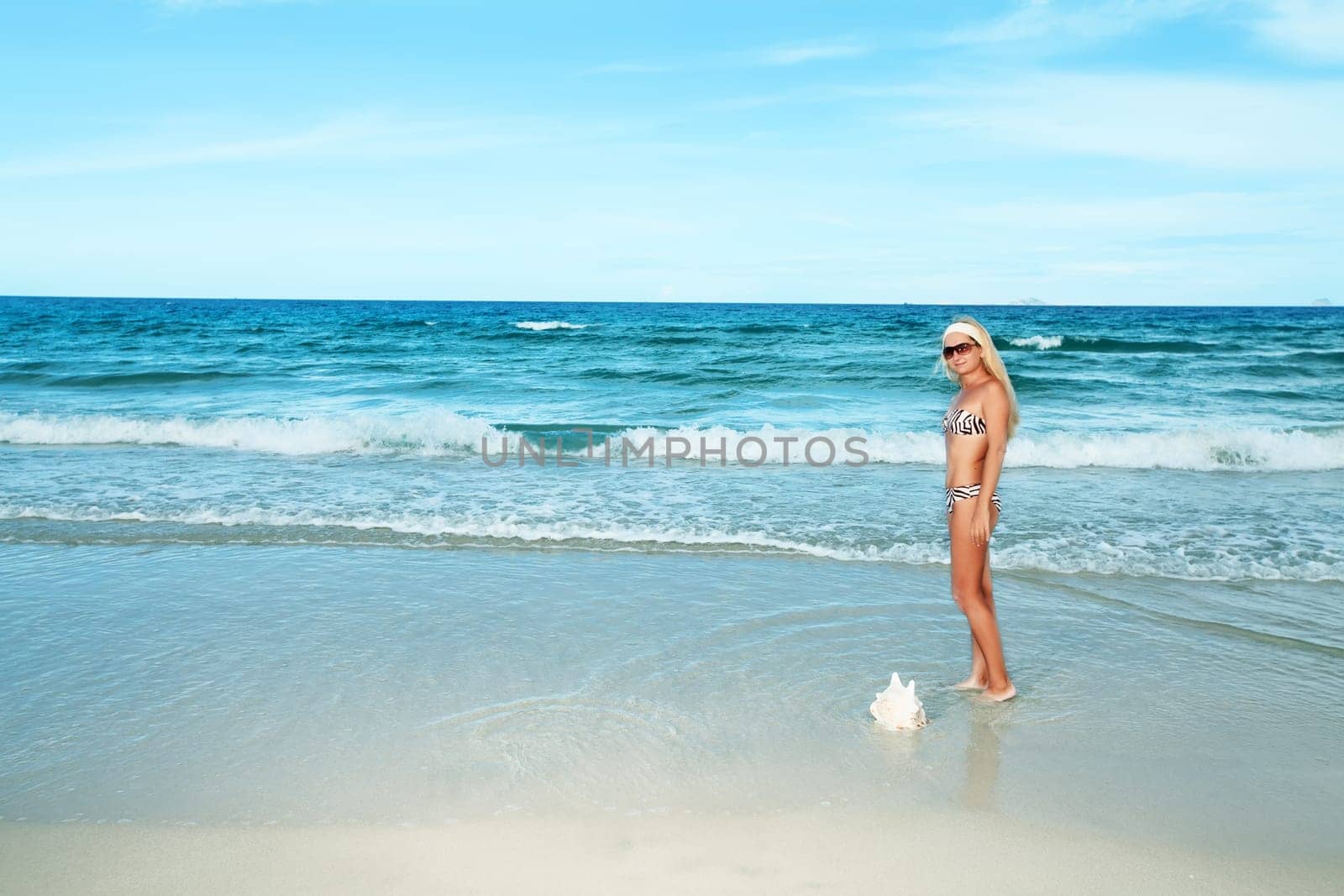 Young woman in bikini at the tropical beach
