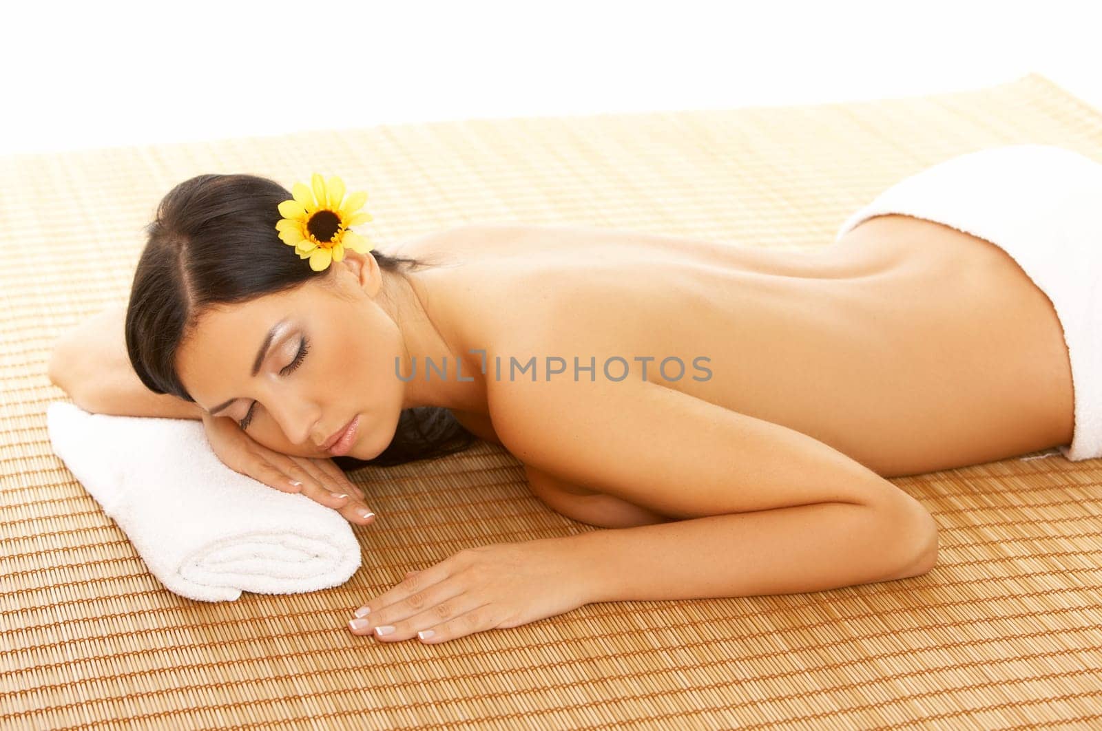 Portrait of Fresh and Beautiful brunette woman laying on bamboo mat