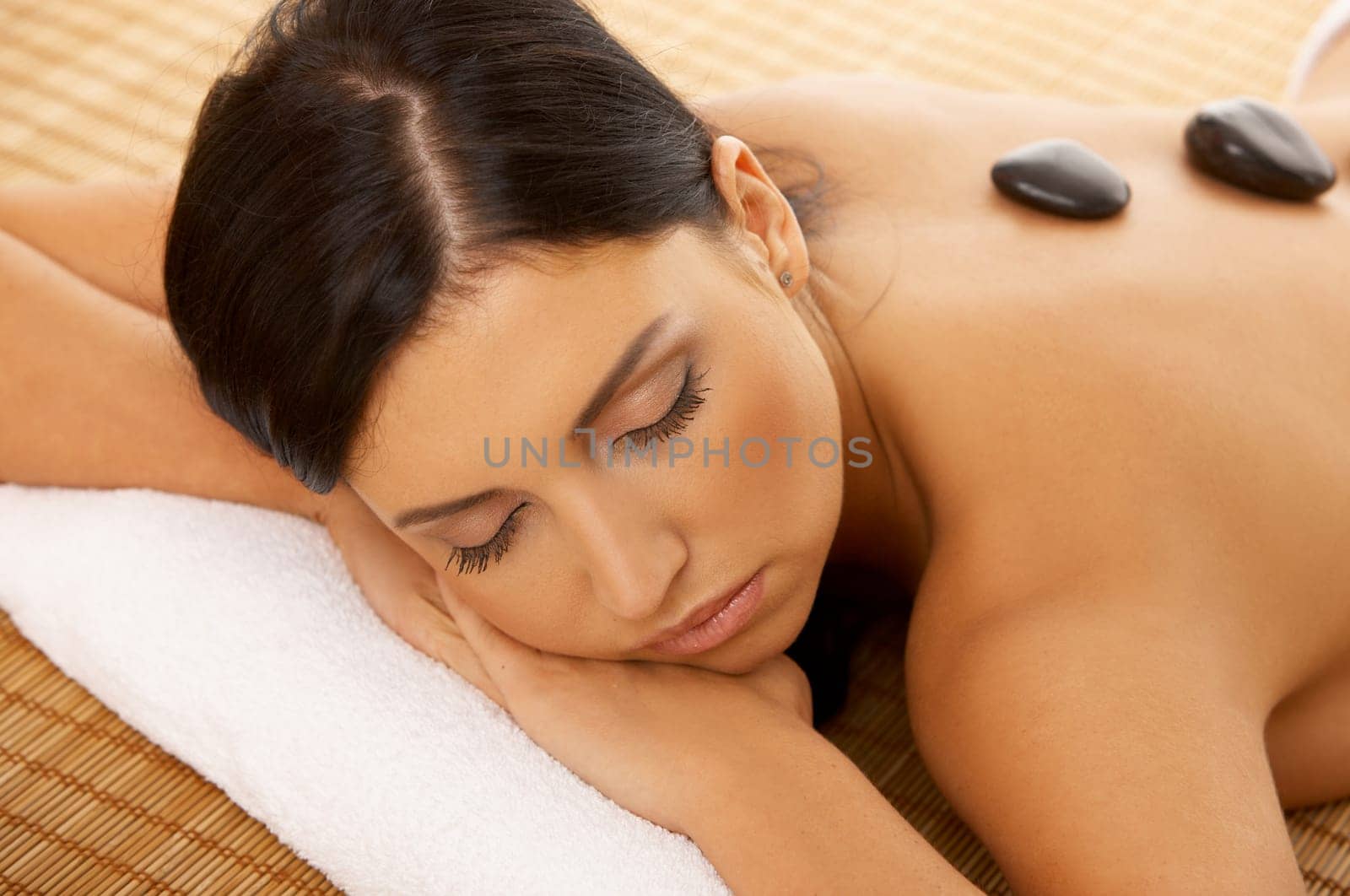 Portrait of Fresh and Beautiful brunette woman taking stone therapy