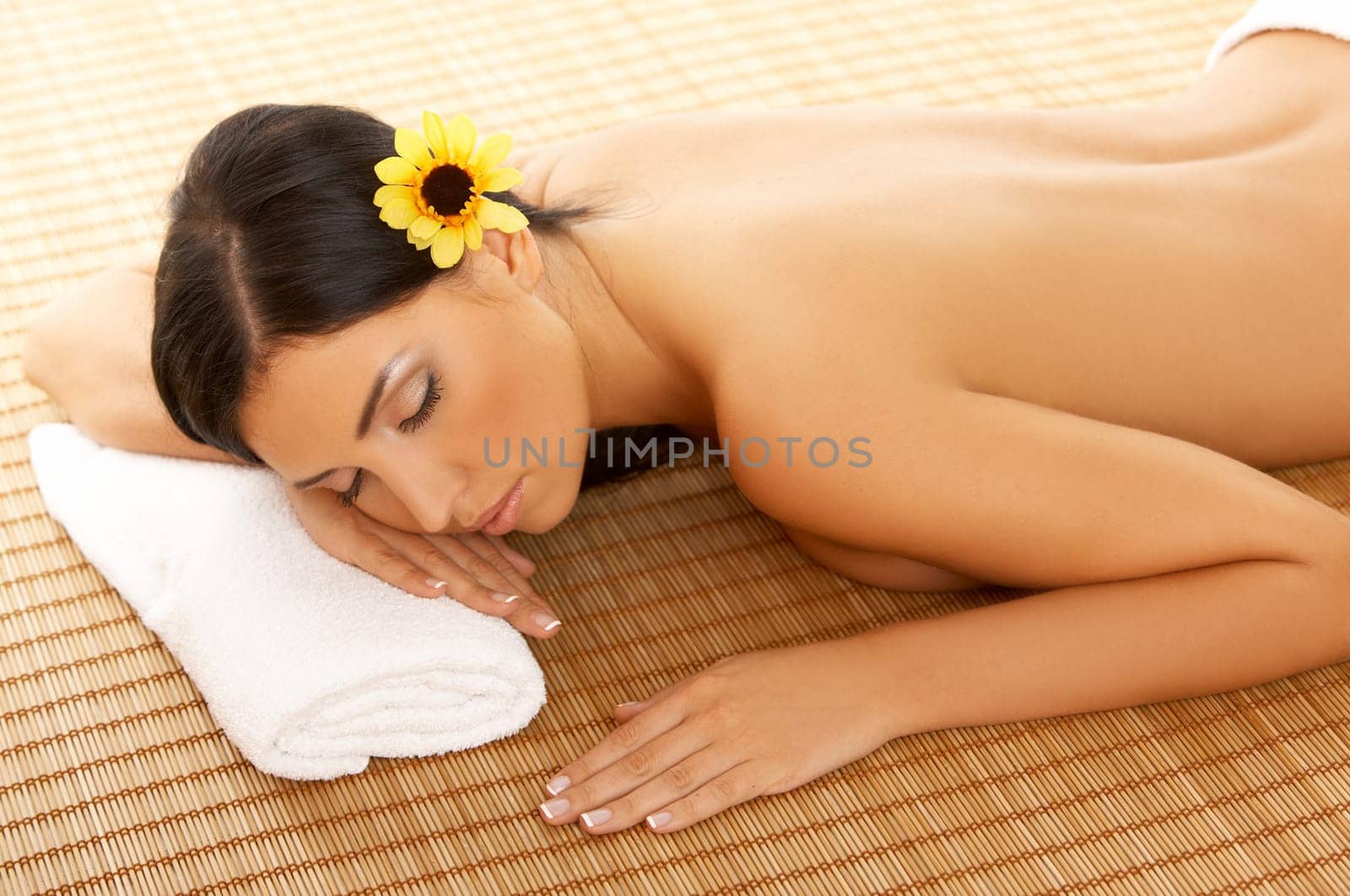 Portrait of Fresh and Beautiful brunette woman laying on bamboo mat