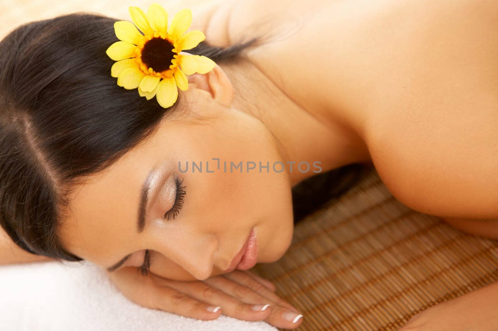 Portrait of Fresh and Beautiful brunette woman laying on bamboo mat