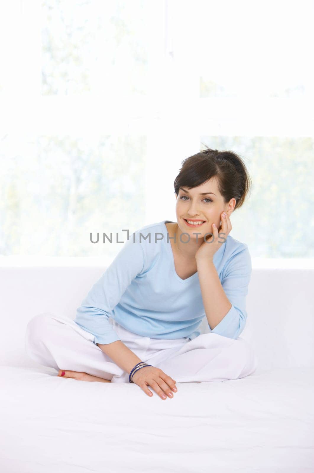 Young woman relaxing on couch in her home