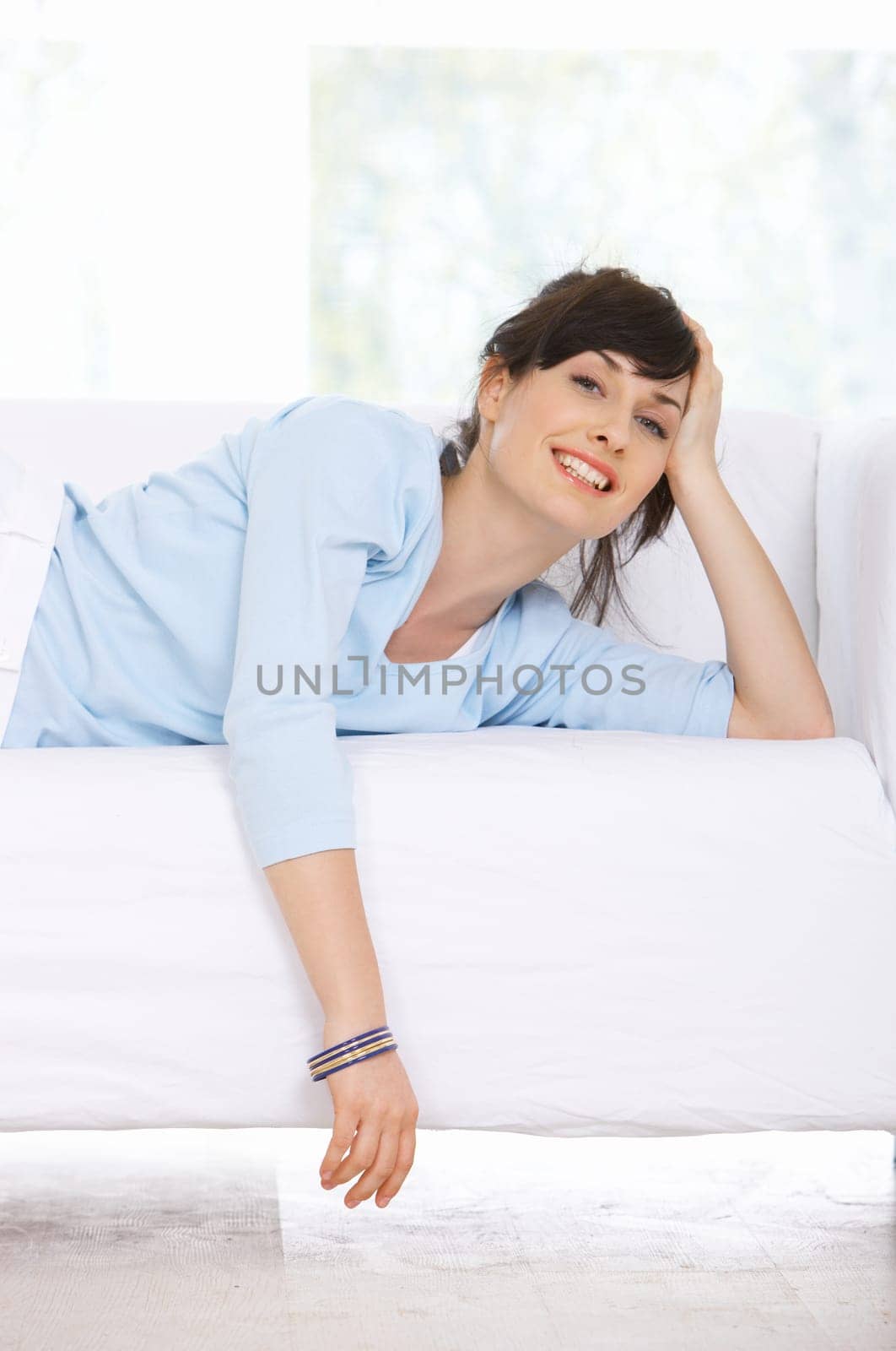 Young woman relaxing on couch in her home
