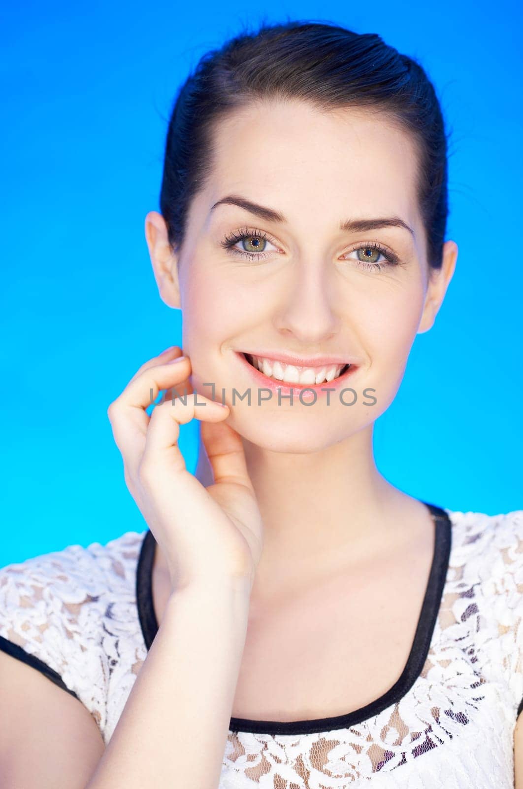 Portrait of 20-25 years old beautiful woman on blue background
