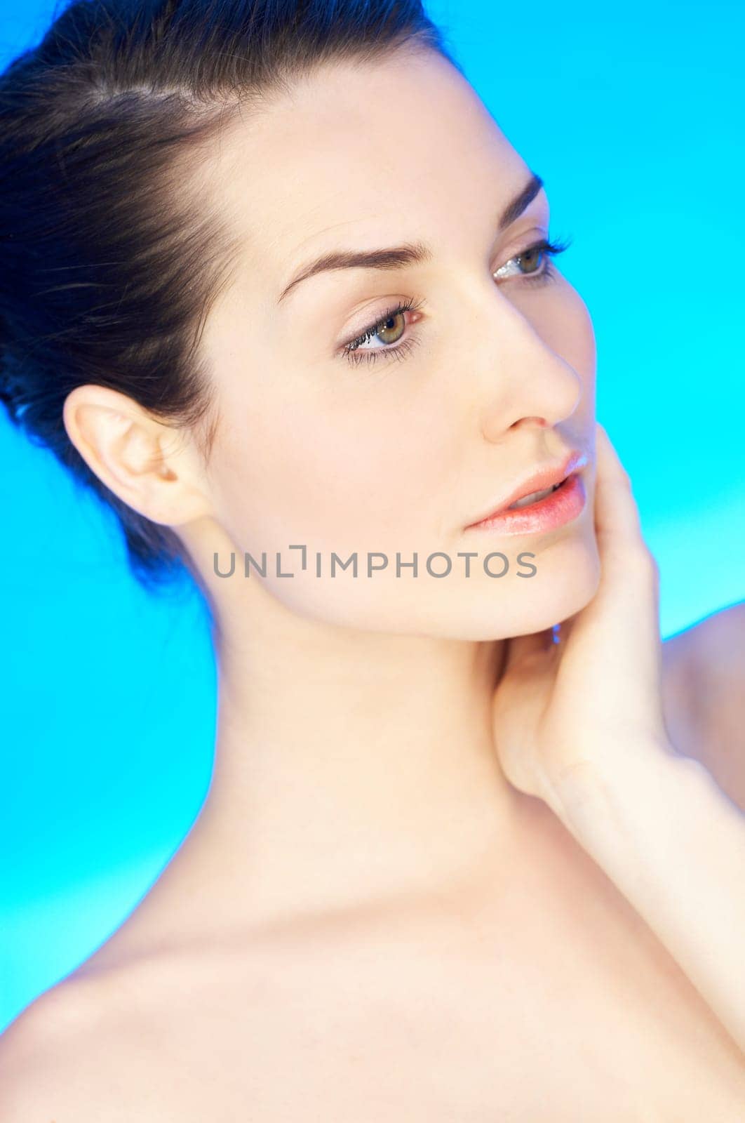 Portrait of 20-25 years old beautiful woman on blue background