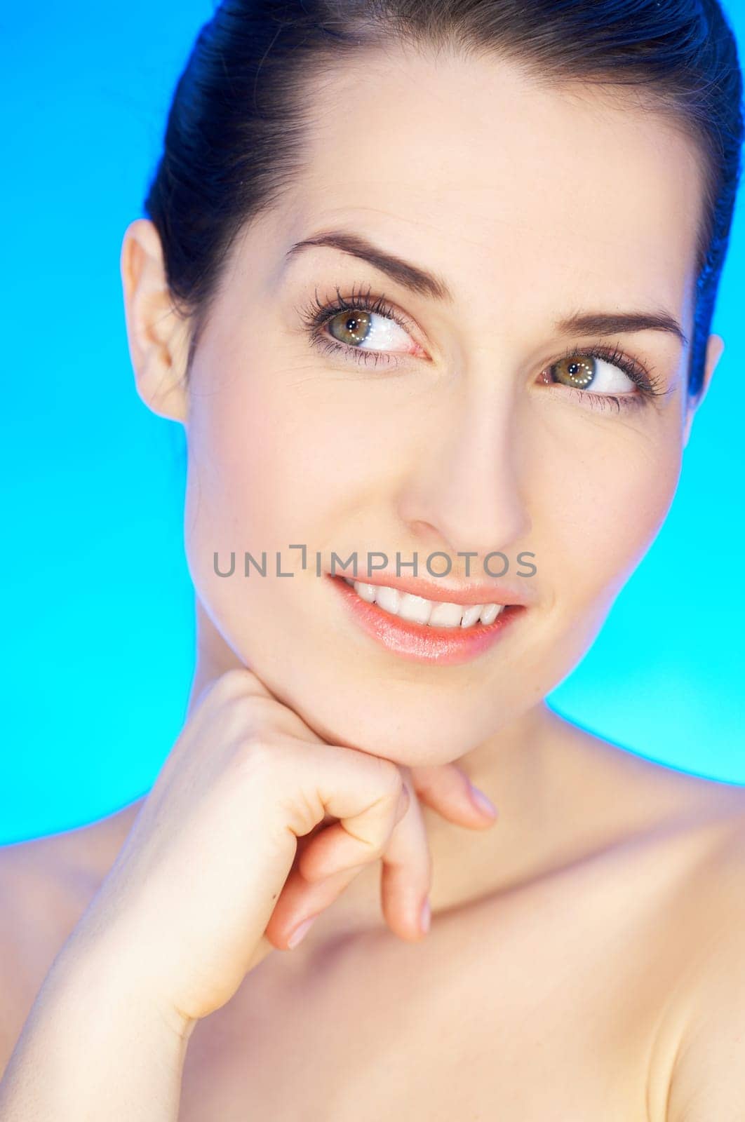 Portrait of 20-25 years old beautiful woman on blue background