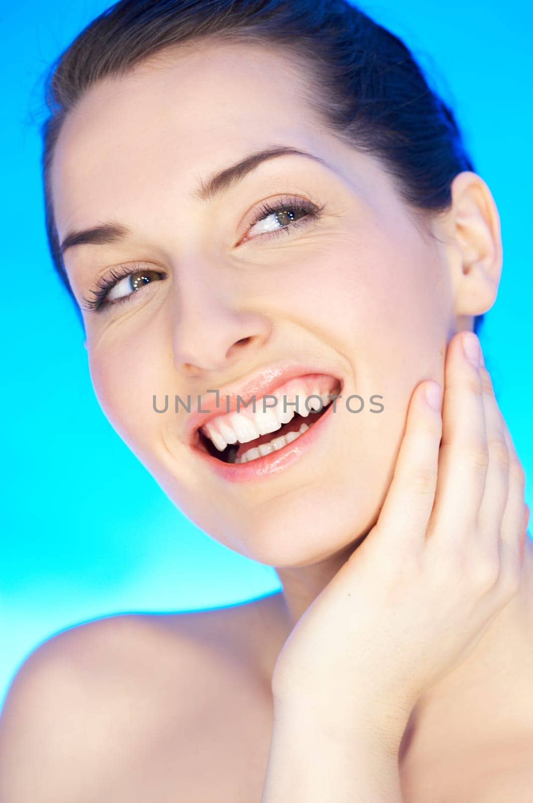 Portrait of 20-25 years old beautiful woman on blue background