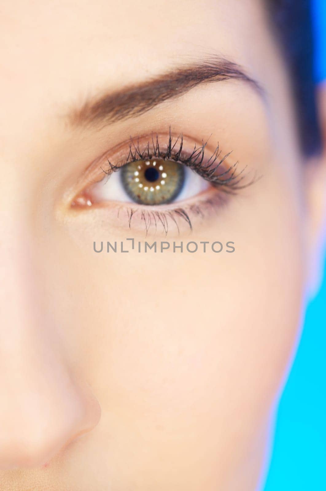 Part of beautiful face of a woman with on blue background