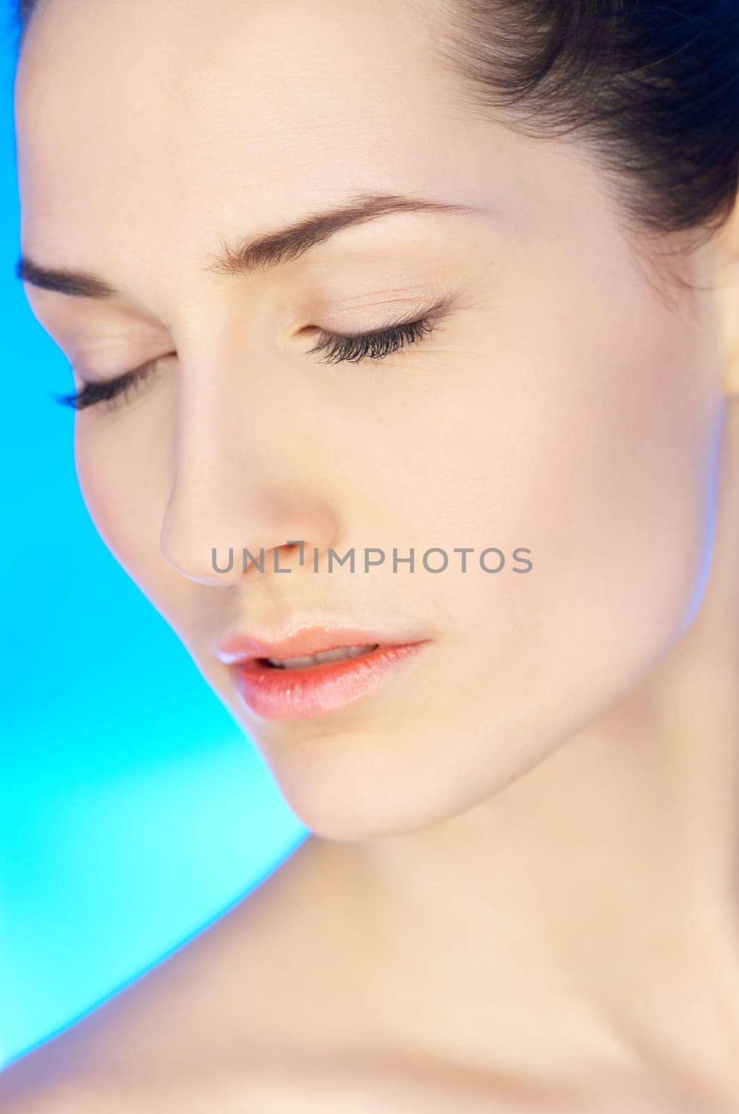Portrait of 20-25 years old beautiful woman on blue background