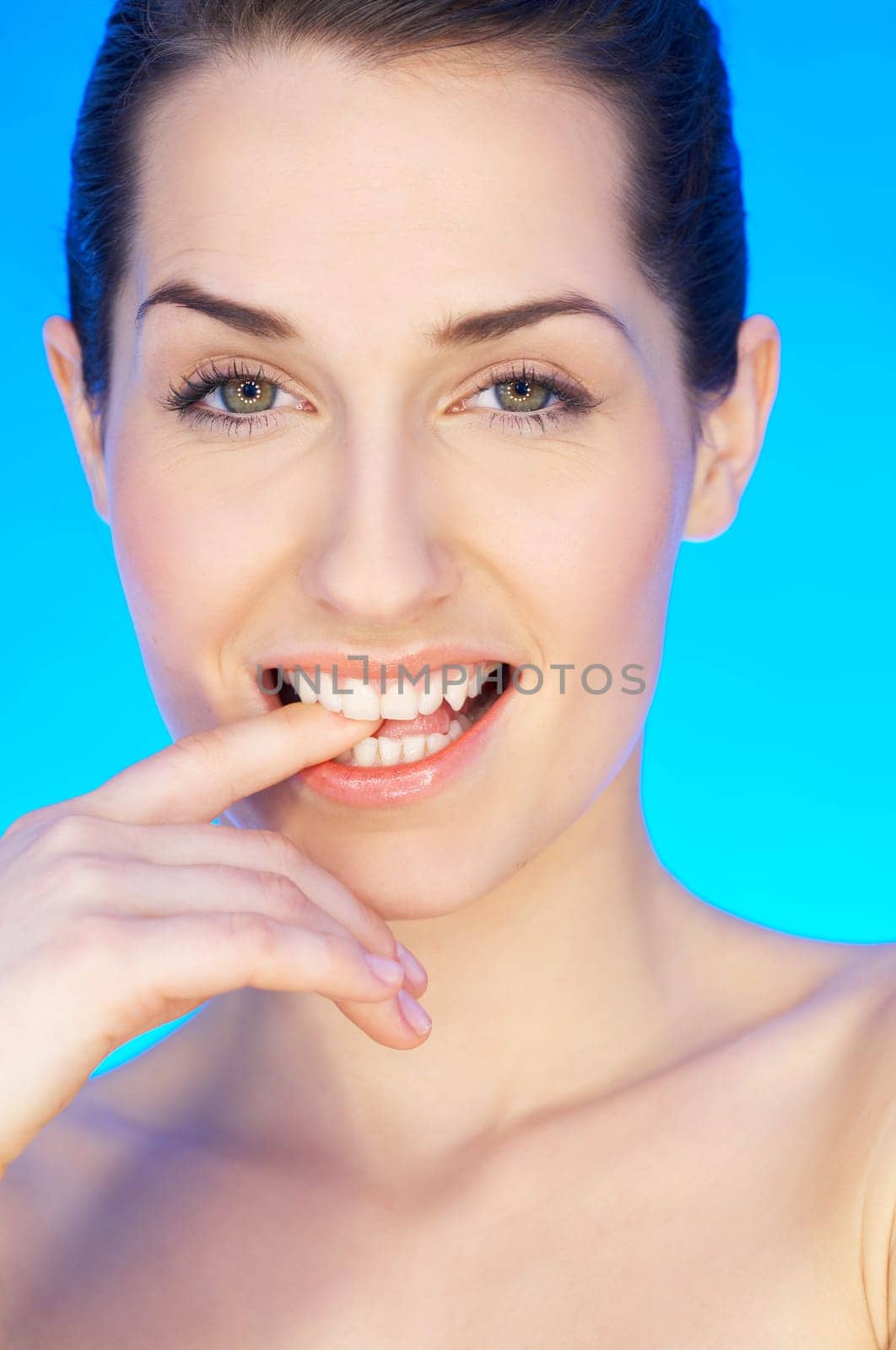 Portrait of 20-25 years old beautiful woman on blue background