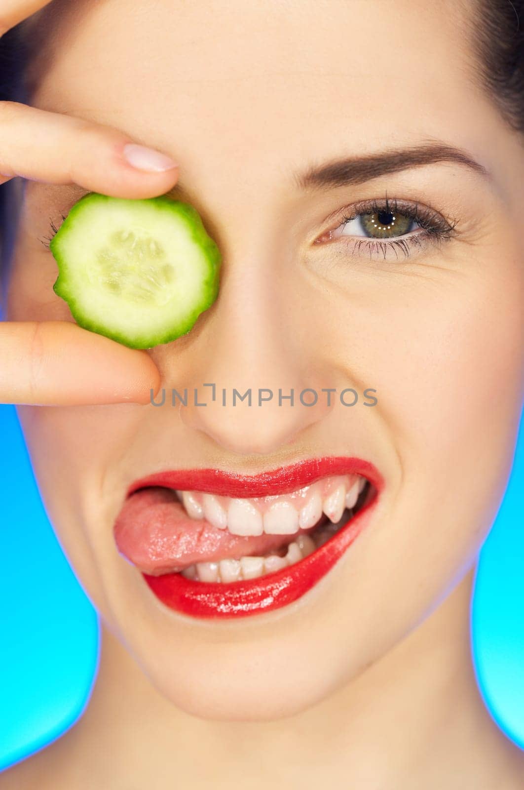 Portrait of beautiful woman with cucumber slice