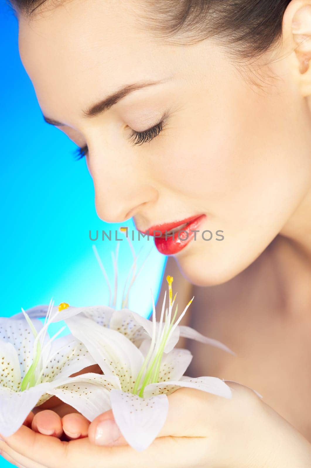 Portrait of beautiful woman holding flowers in hands