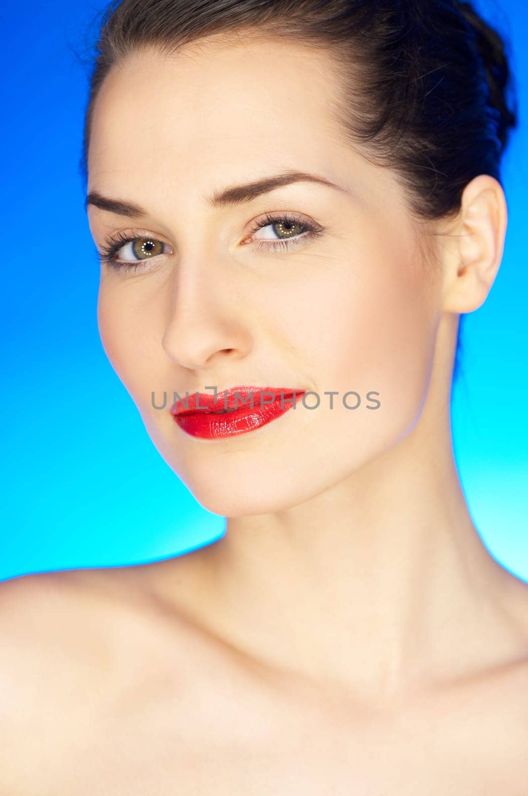 Portrait of 20-25 years old beautiful woman on blue background