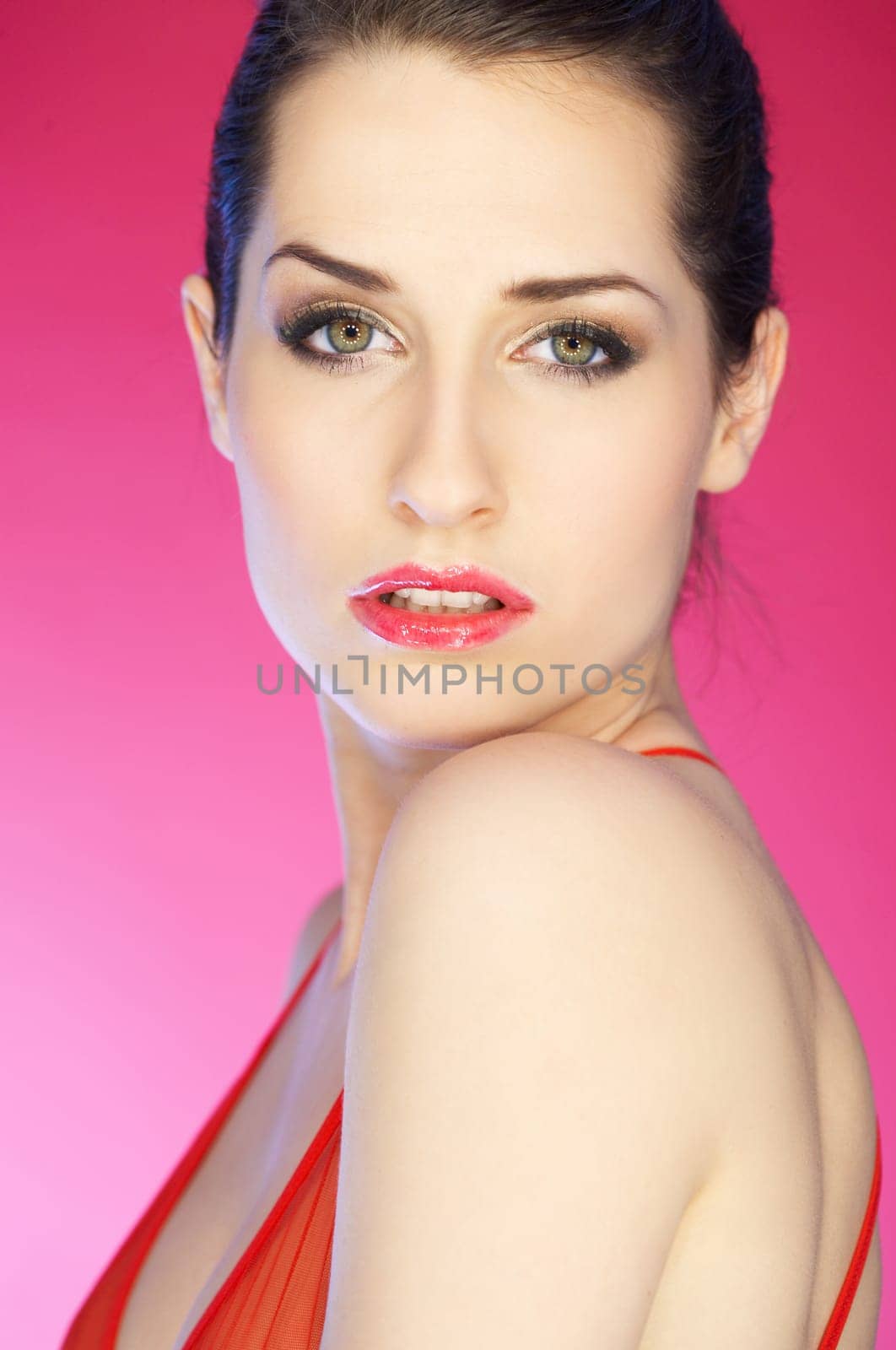 Portrait of beautiful woman on pink background