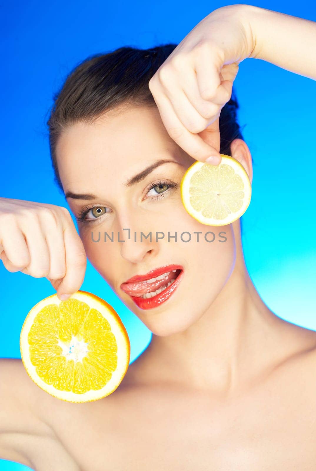 Portrait of beautiful woman with citrus slices