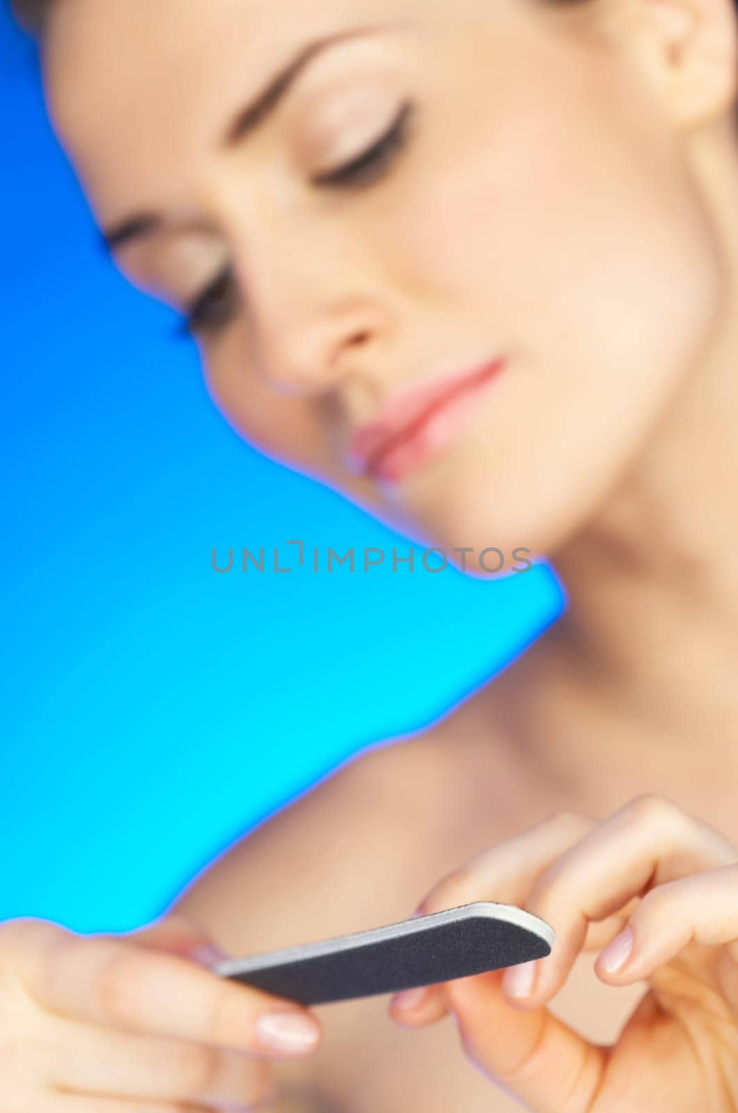 Portrait of beautiful woman doing her finger nails