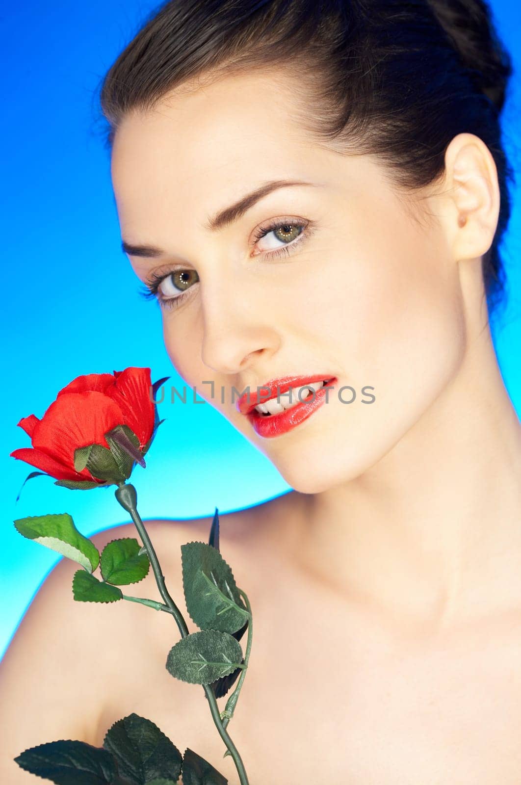 Portrait of beautiful woman with red rose
