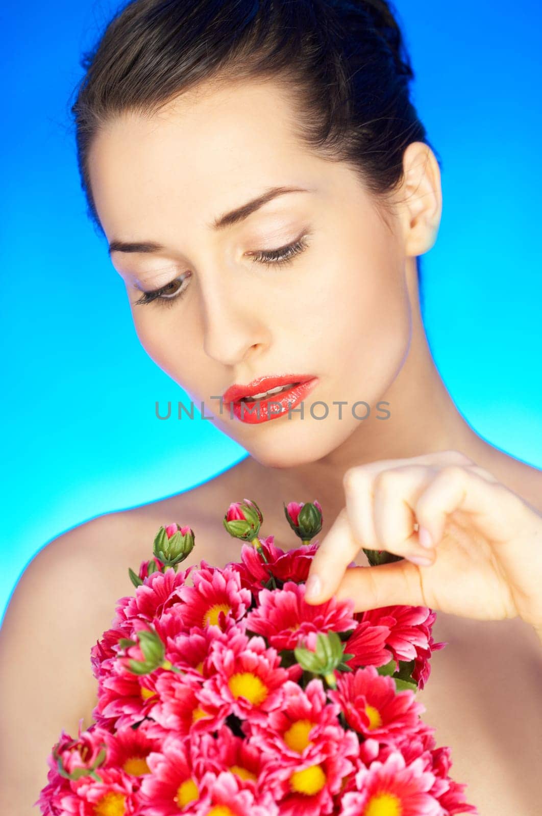 Portrait of beautiful woman holding bunch of flowers