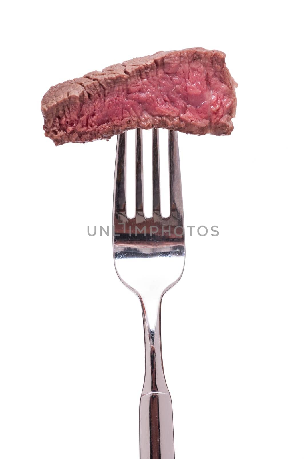 Roasted piece of beef tenderloin on a fork is white isolated