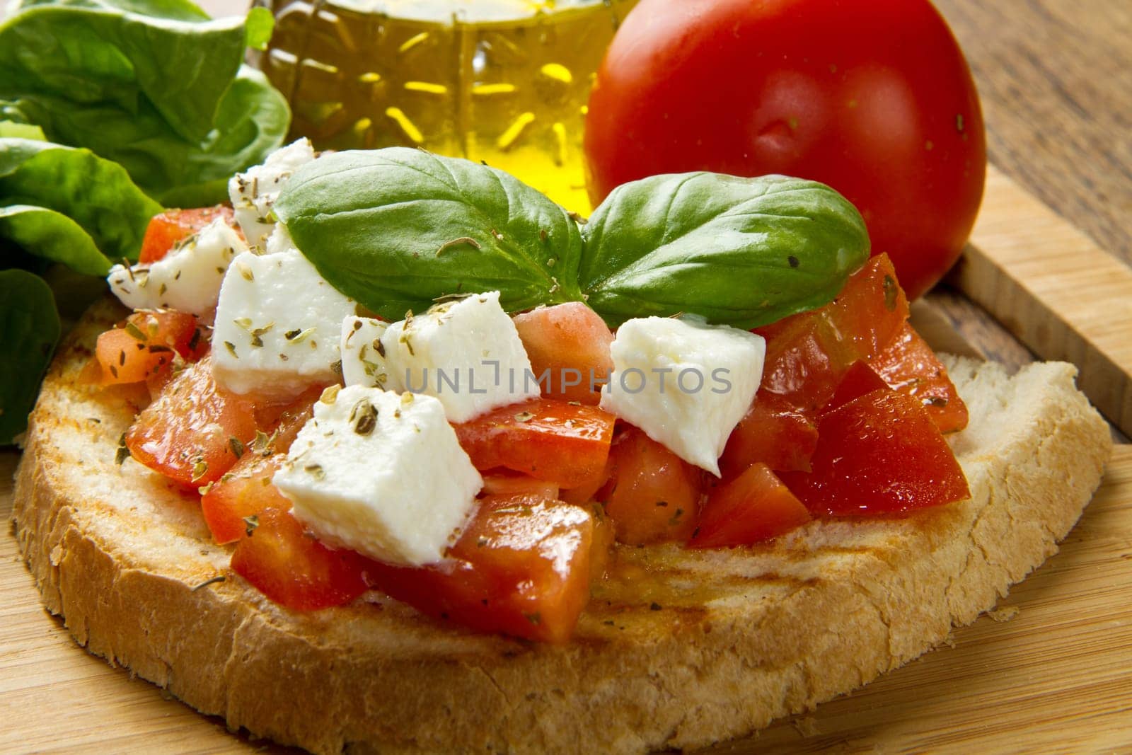 italian bruschetta with fresh tomatoes, basil, garlic, olive oil and cheese