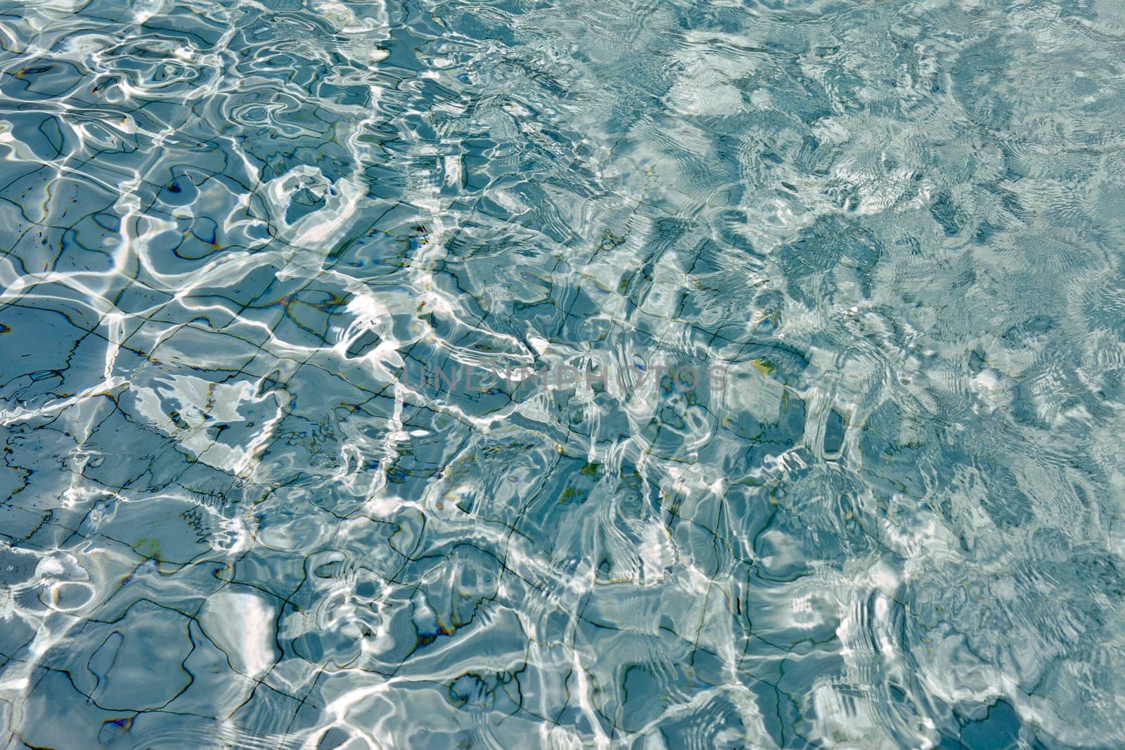 The Most beautiful clear pool water reflecting in the sun