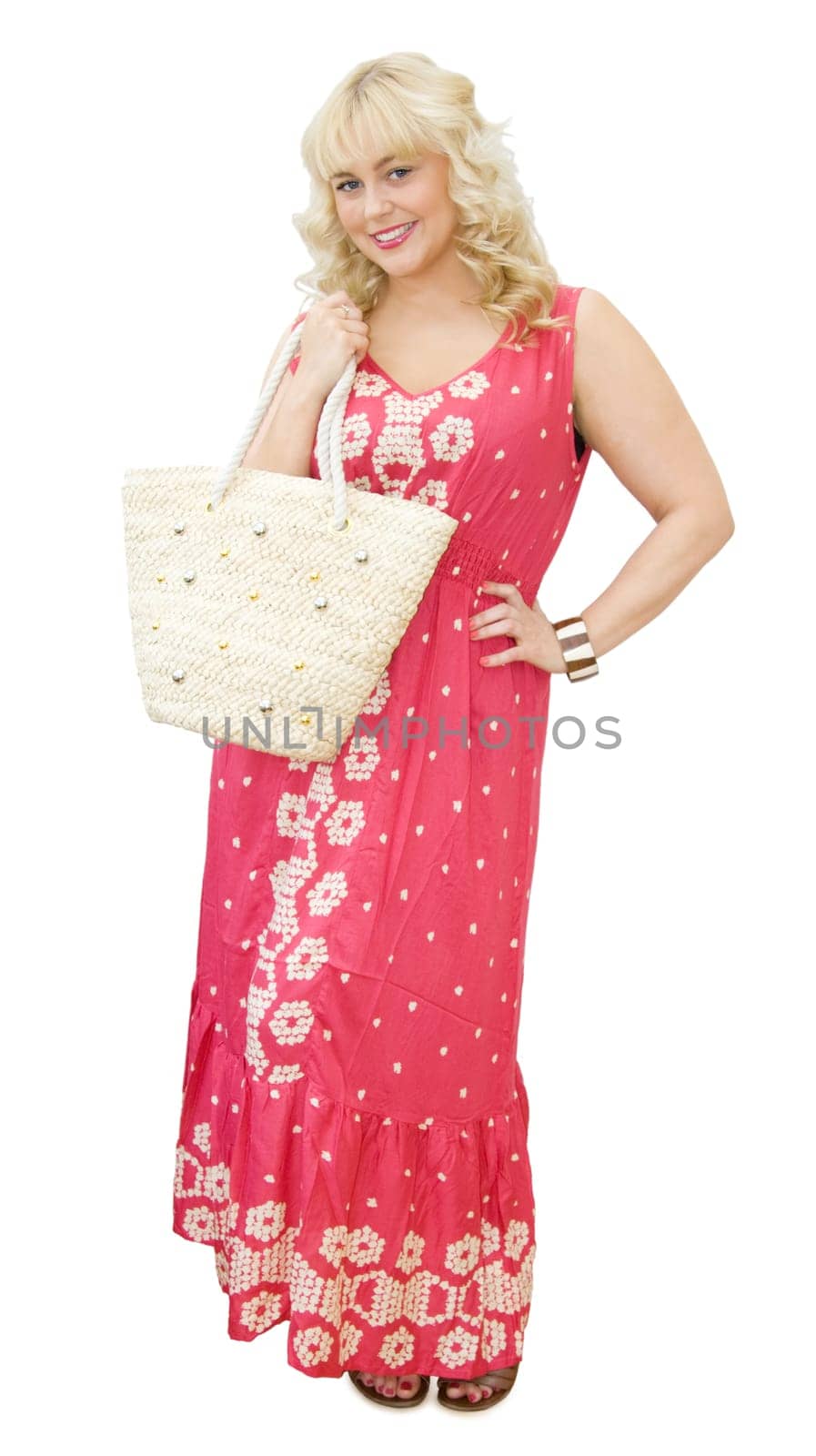Summer holidays fun - beautiful blonde woman with beach bag and maxi dress, smiling and getting ready to go to the beach or shopping. Isolated over white background.