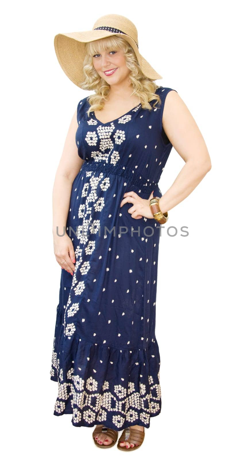 Summer vacations - beautiful young woman wearing straw hat and flowery maxi dress. Getting ready for fun summer holidays. Isolated over white background.